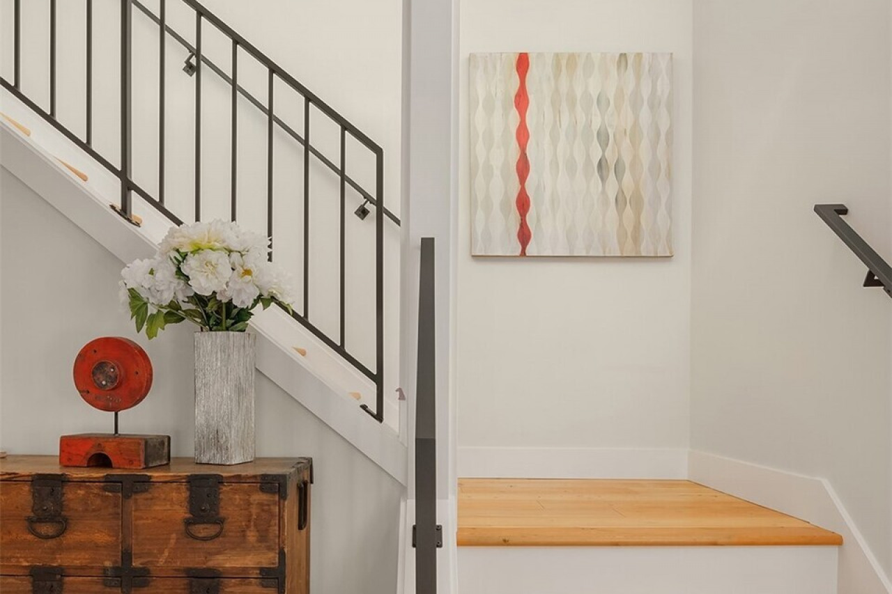 Stunning custom metal railings enhance the open entry stairway. Stunning custom metal railings enhance the open entry stairway.