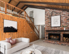 The floor-to-ceiling, extra-large wood-burning fireplace serves as a stunning focal point, adding warmth, character, and a touch of rustic elegance to the space.