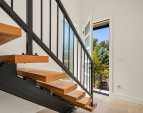 A beautiful floating staircase greets you at the entrance