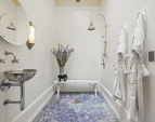 The bathroom is tiled without grout to eliminate maintenance, similar to the French Underground Metro.