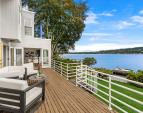 An expansive deck opens up to the shimmering water.