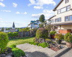 Partially fenced yard takes in the views of the town and the river