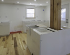 Kitchen island with plantation sink will have quartz countertops and a dishwasher on the far side. Base cabinets will have uppers along the wall, to be installed soon.