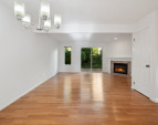 Dining room with view towards living and back deck - shown without staging - look at those floors!