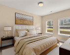 Comfortable secondary bedroom with soft natural light and ample closet space