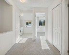 Upper hall with linen closets and pull down ladder to extra storage attic above.