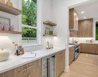 Butler’s pantry with built-in shelves, pull-out cabinets, and soft-close mechanisms. Includes an Avallon undercounter wine and beverage refrigerator for entertaining.
