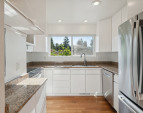 Updated kitchen with high end appliances, granite counters and extra tall cabinets for great storage!