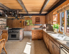 The kitchen is bathed in natural light, seamlessly flowing into the living space and featuring elegant terrazzo floors for a stylish and timeless touch.