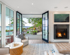 The kitchen, dining, and living areas share the warmth of a custom Town & Country fireplace.