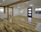 Main floor flooring and kitchen installation ongoing to the left.