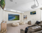 Epson PowerLite home theater projector, a 134" framed and wall-mounted UHD projection screen