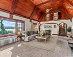 Stunning mahogany paneling and millworker frame the expansive windows, taking in the light and the views