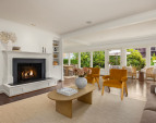 Living room and a wall of windows along the back of the home flood this home with sunshine and light.