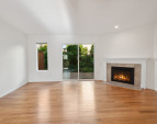 Dining room with view towards living and back deck - shown without staging - look at those floors!