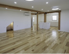 View from the waterside of the living room showing the back entry hallway and the stairway on the left. Ongoing kitchen installation and island cabinetry just to the right of center.