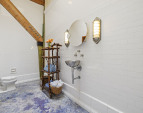 The bathroom is tiled without grout to eliminate maintenance, similar to the French Underground Metro.