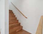 Wood stairs lead to the second level bedrooms and primary suite.