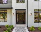Impressive two-story covered foyer designed for both style and privacy.