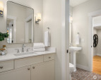 Custom painted cabinetry and pocket door that separates the bath spaces. Custom painted cabinetry and pocket door that separates the bath spaces.