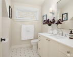 A large upstairs bath with tub features custom patterned tile and is shared by the two upstairs bedrooms. A large upstairs bath with tub features custom patterned tile and is shared by the two upstairs bedrooms.