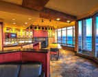 Open concept kitchen features European appliances, plumbed for gas cooking; gas fireplace; granite counters and a stainless counter with a deep sink.