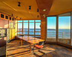 Open kitchen features spectacular water and mountain views, built-in window seat in bay window; floor to ceiling sliding door leading to a covered view terrace