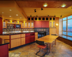Meticulous custom designed maple and anigre hardwood cabinetry are found throughout.