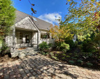Paleo stones lead through the gardens to the original entrance of the home. New roof and all new exterior paint!