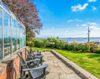 View from side yard to Commencement Bay and breathtaking Mount Rainier (looms large on a clear day)!