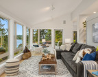 The living room has a beautiful view of Rich Passage and overlooks the gardens. Vaulted ceilings, maple floors and a French door to the deck outside.