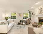 Tall windows offer views to the front lawn and gardens. Wood burning fireplace with custom surround and mantle. Tall ceilings.