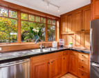Quality quartz counters, custom cherry cabinetry, Vertical Grain Fir Windows (throughout the entire home) and view to the garden