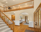 Grand entry with flowing hardwood floors.