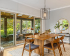 The dining room is open to the living room, kitchen and garden room