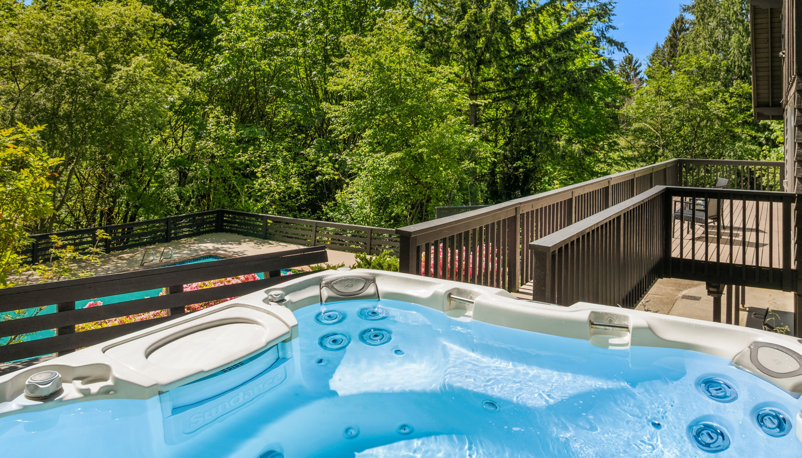 Unwind in the hot tub while enjoying a peek-a-boo view of Lake Sammamish, offering the perfect blend of relaxation and natural beauty.