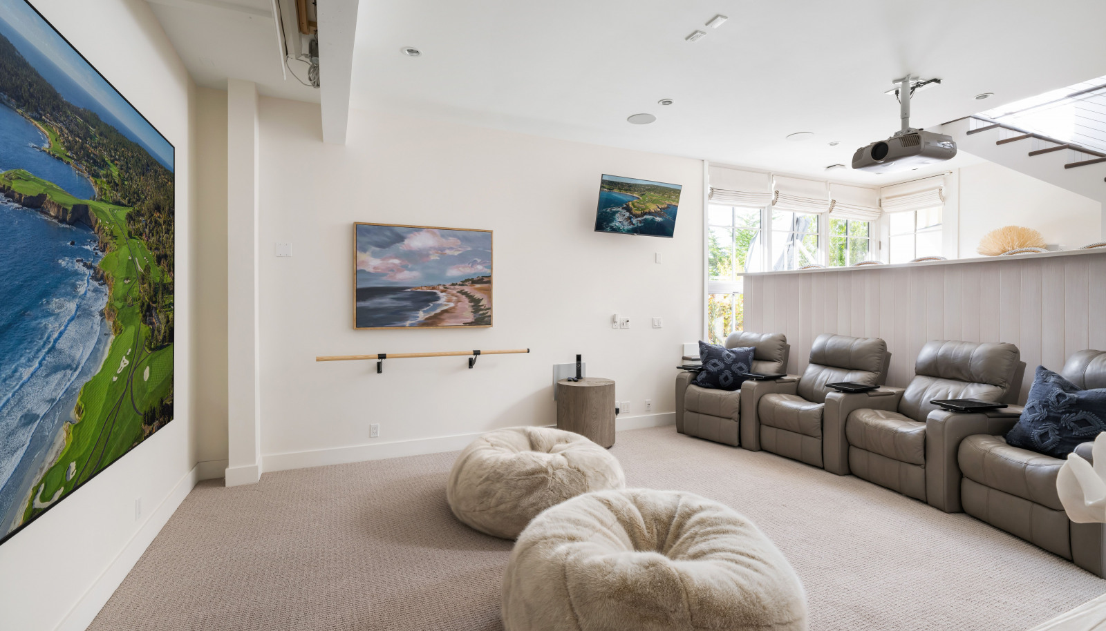 The room offers direct access to the deck and jacuzzi, as well as a Sub-Zero 18" integrated wine refrigerator, a 36" Sub-Zero fridge with two-drawer freezer and ice maker & W/D