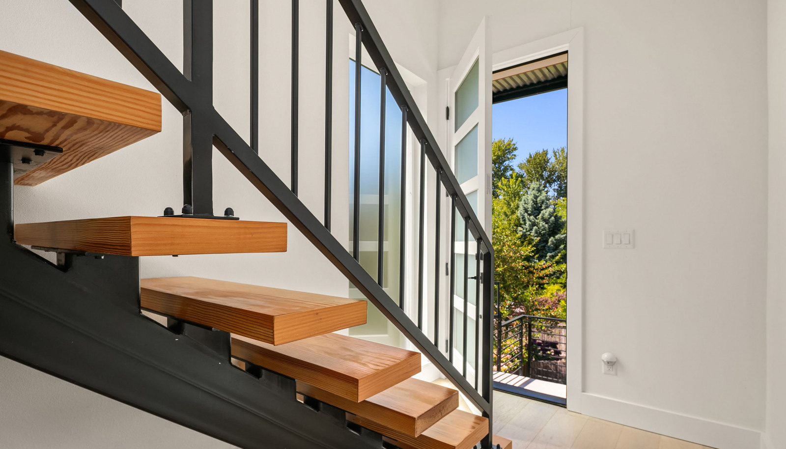A beautiful floating staircase greets you at the entrance