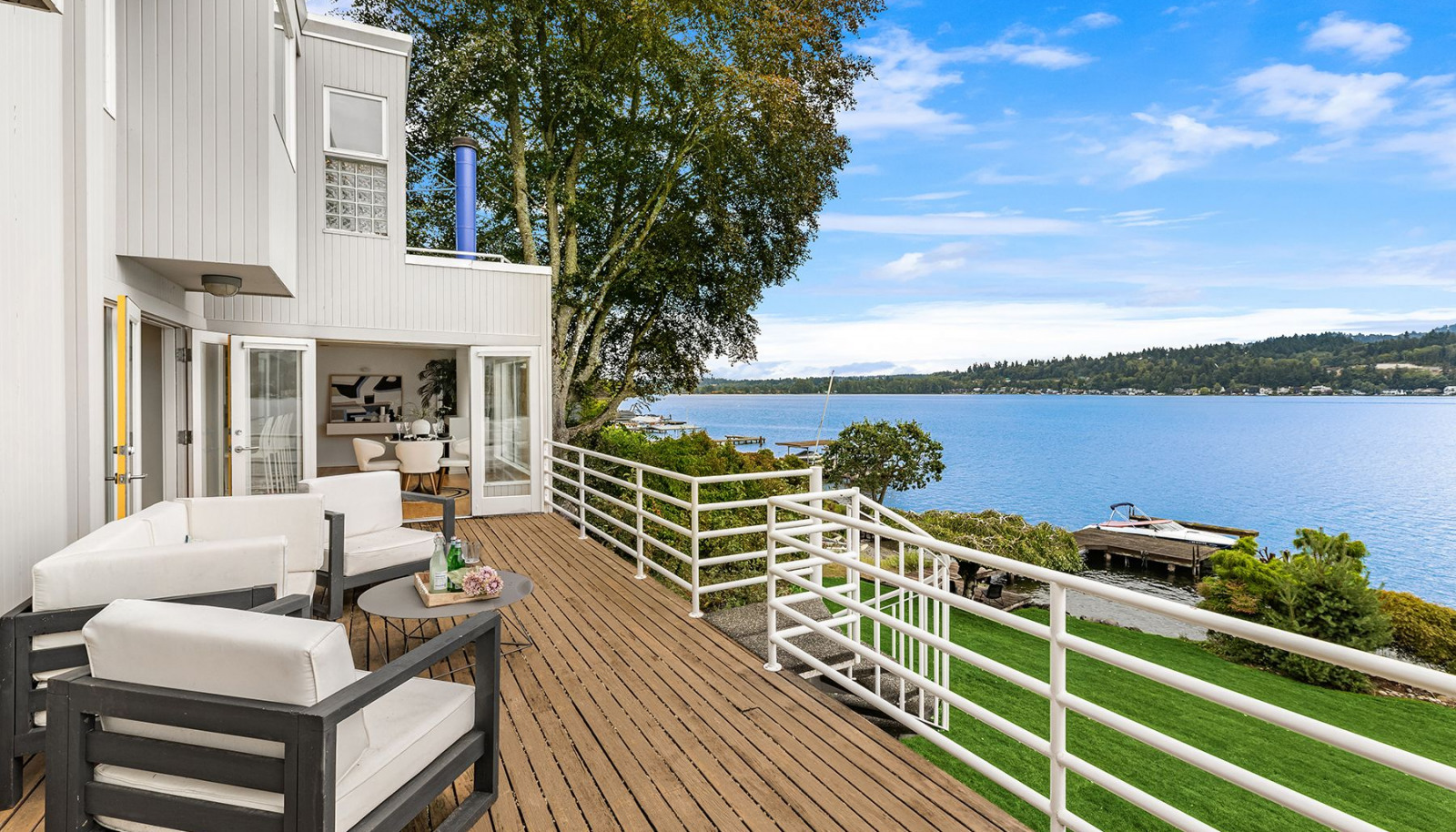 An expansive deck opens up to the shimmering water.
