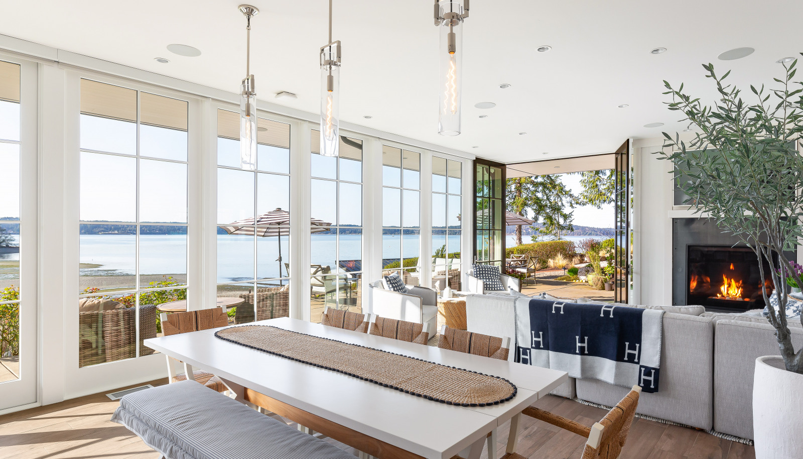 Floor-to-ceiling custom Pella Architectural Series doors and windows create seamless indoor/outdoor living.