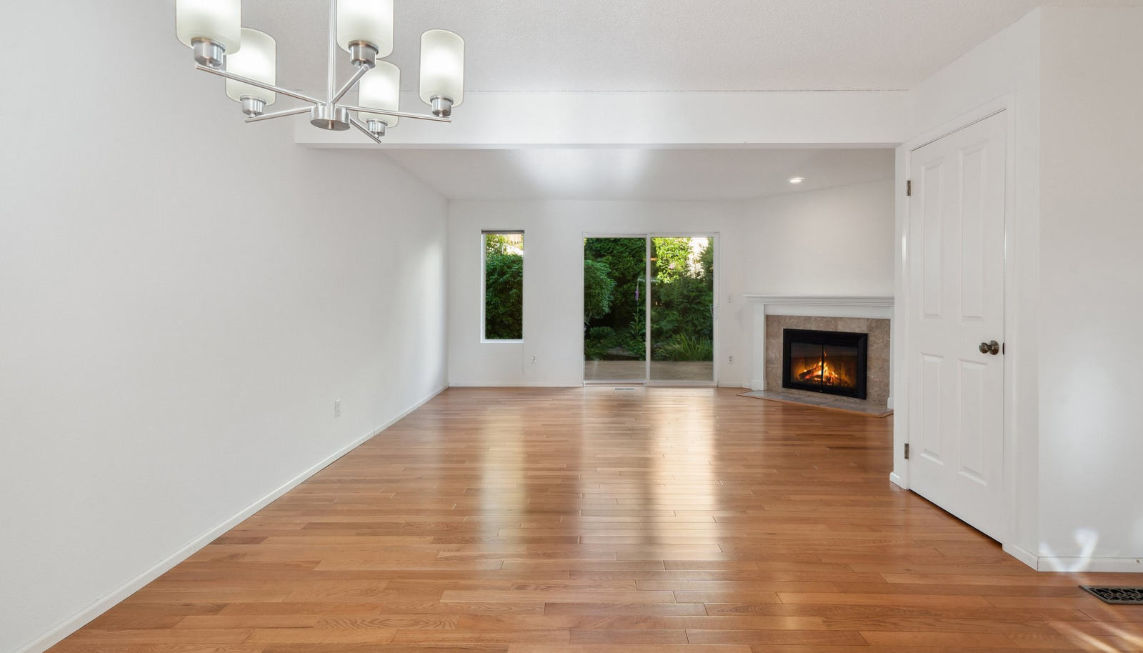 Dining room with view towards living and back deck - shown without staging - look at those floors!