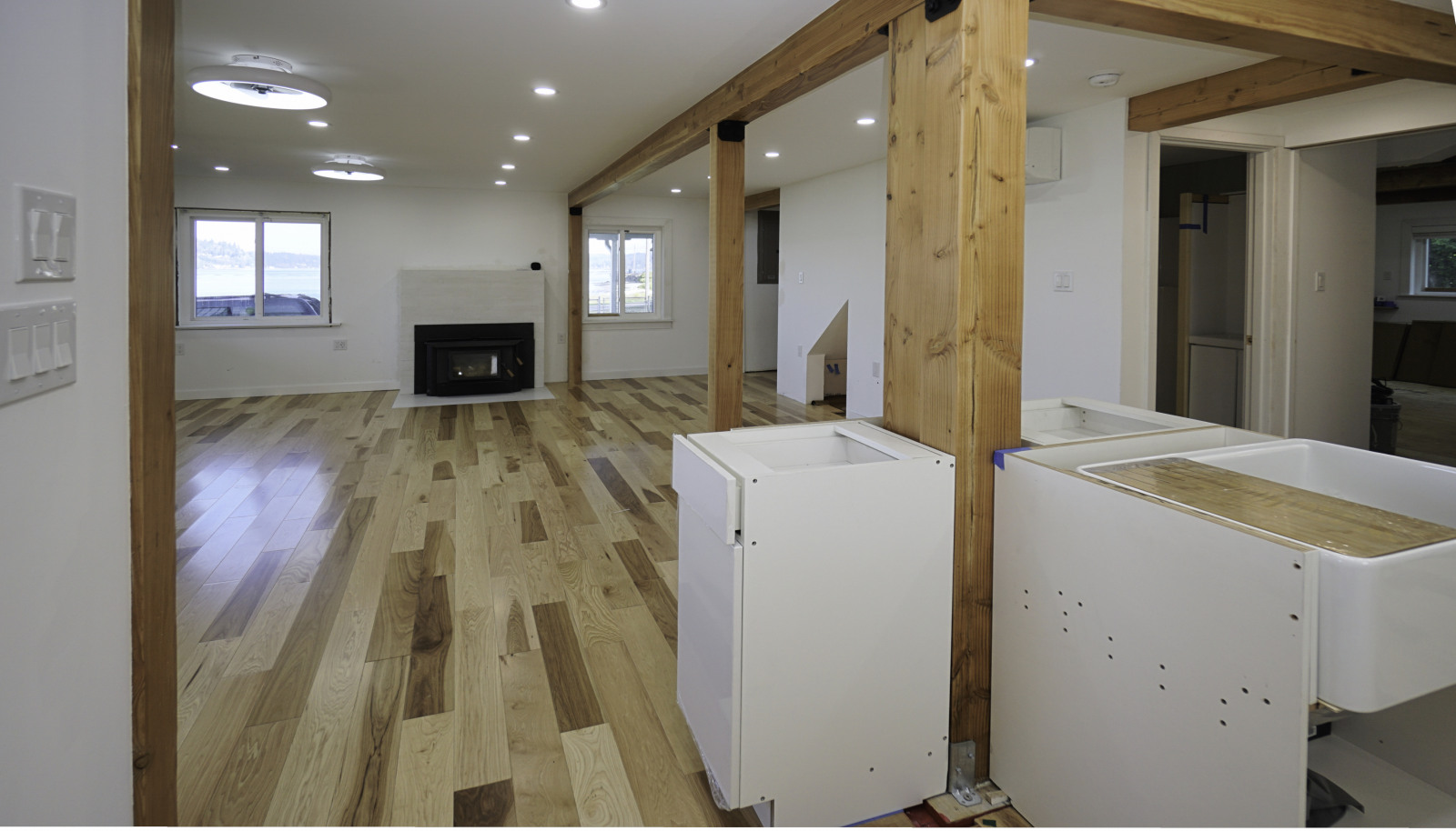 The dishwasher will be installed next to the plantation sink. Quartz countertops to cover every part of the island all the way around the center post. The first doorway to the right of center is the 3