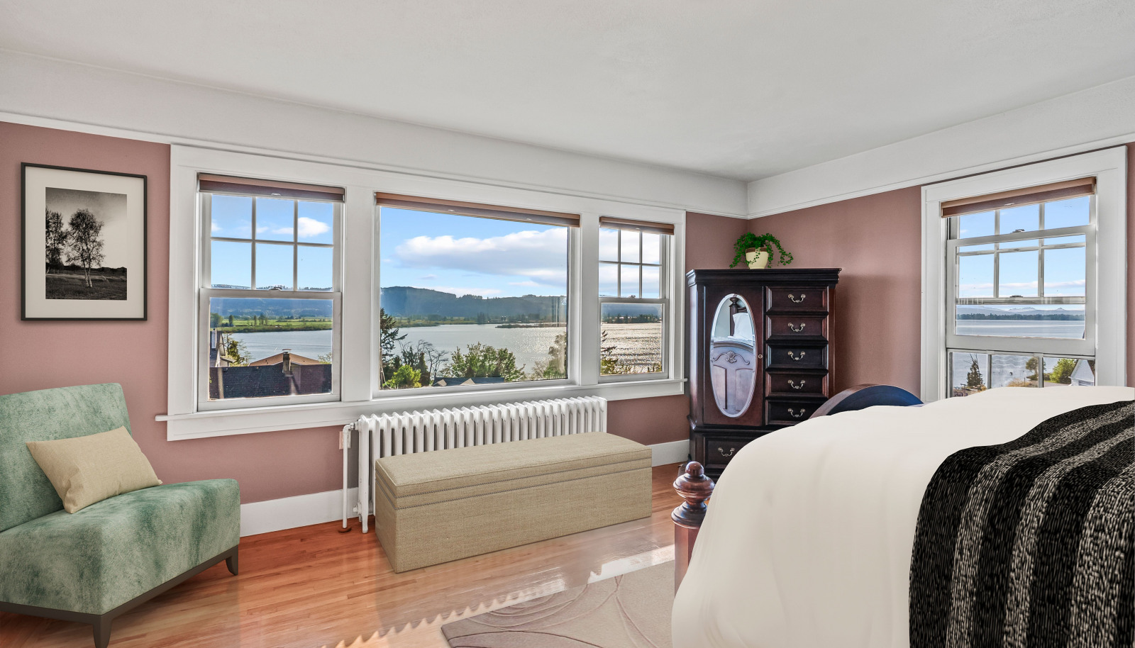 Primary bedroom with sweeping views of the Columbia River and Puget Island. Note: Partially virtual staging