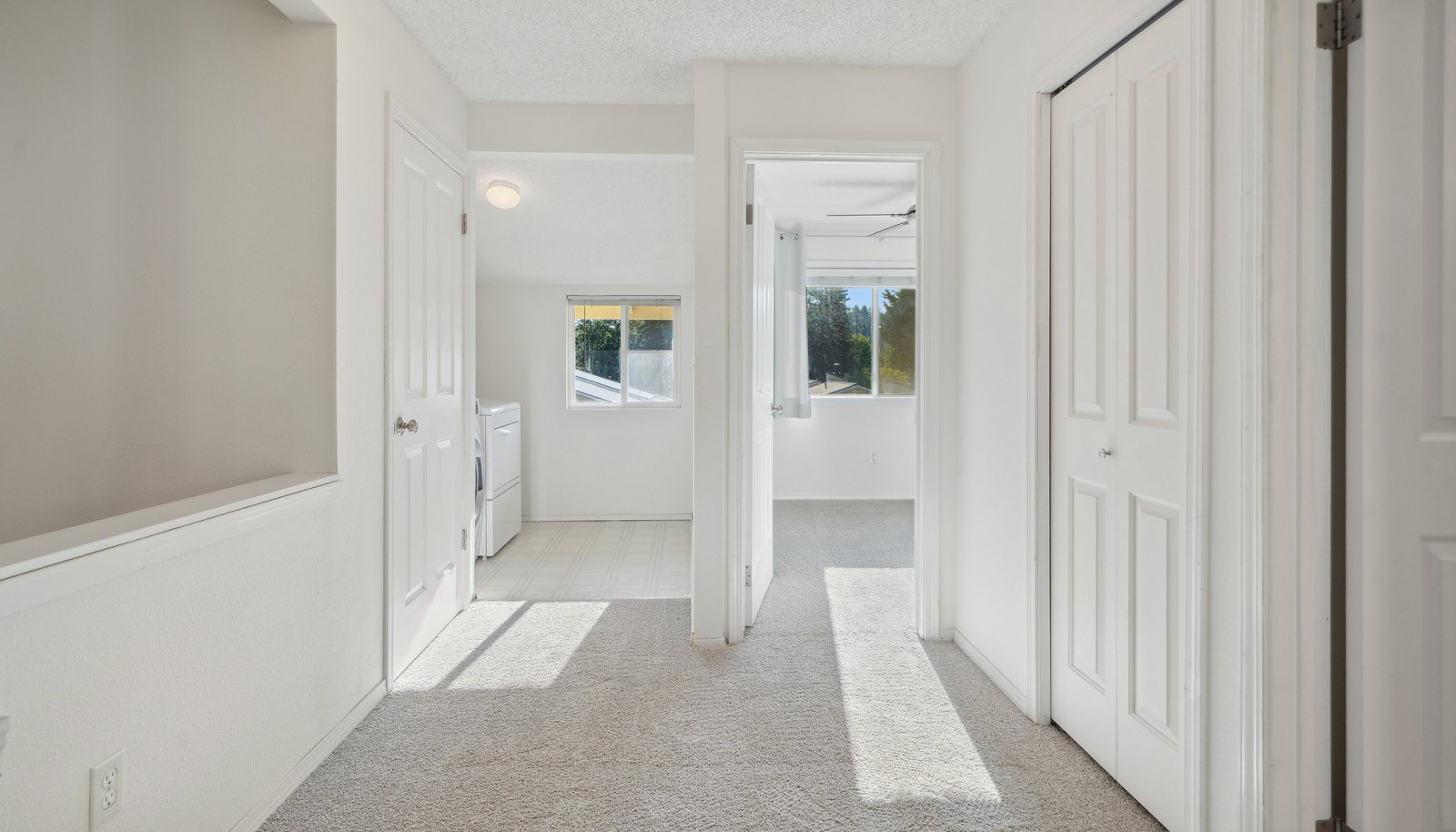 Upper hall with linen closets and pull down ladder to extra storage attic above.
