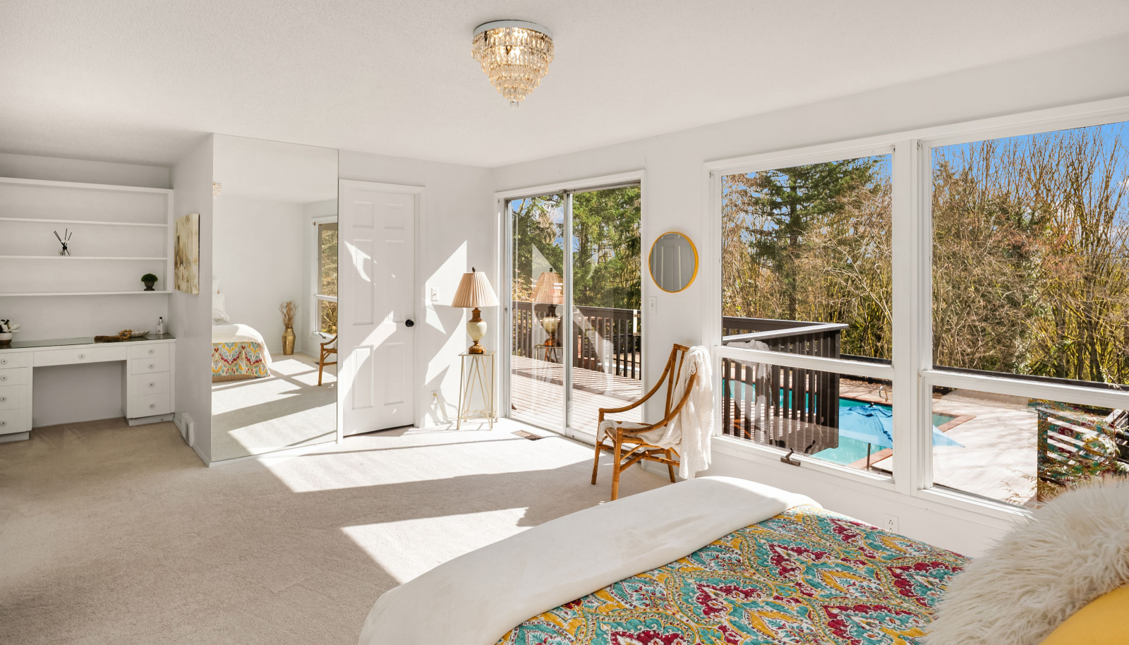 The primary suite opens directly to the expansive deck, offering serene views and the ultimate in privacy, creating a peaceful retreat.