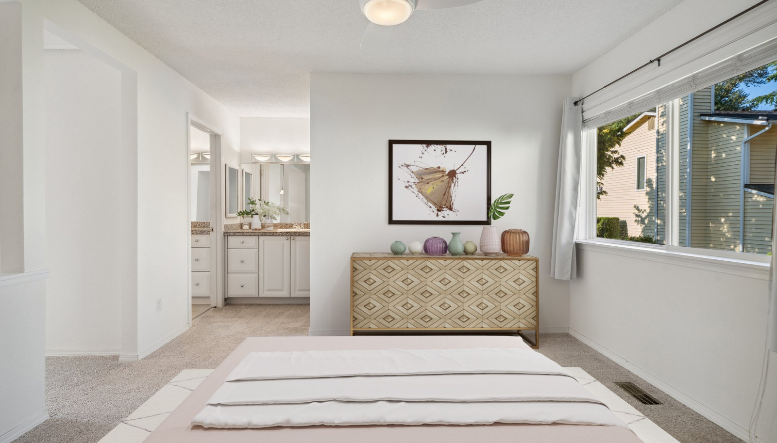 Primary bedroom with view towards sink area and vanity. Virtually staged to give you a sense of the potential!
