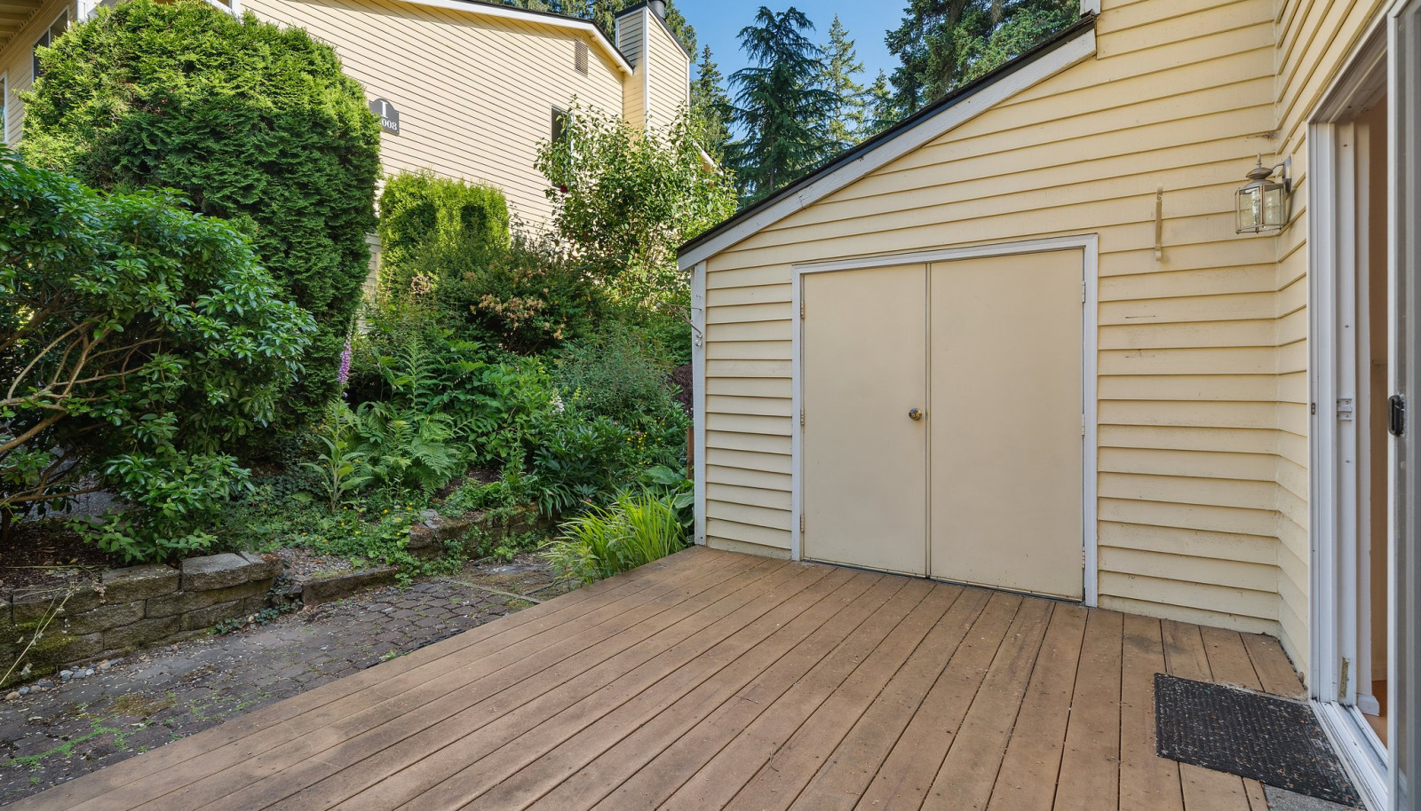 Private deck off living room with locked storage. Nice private greenscape and place to barbeque!