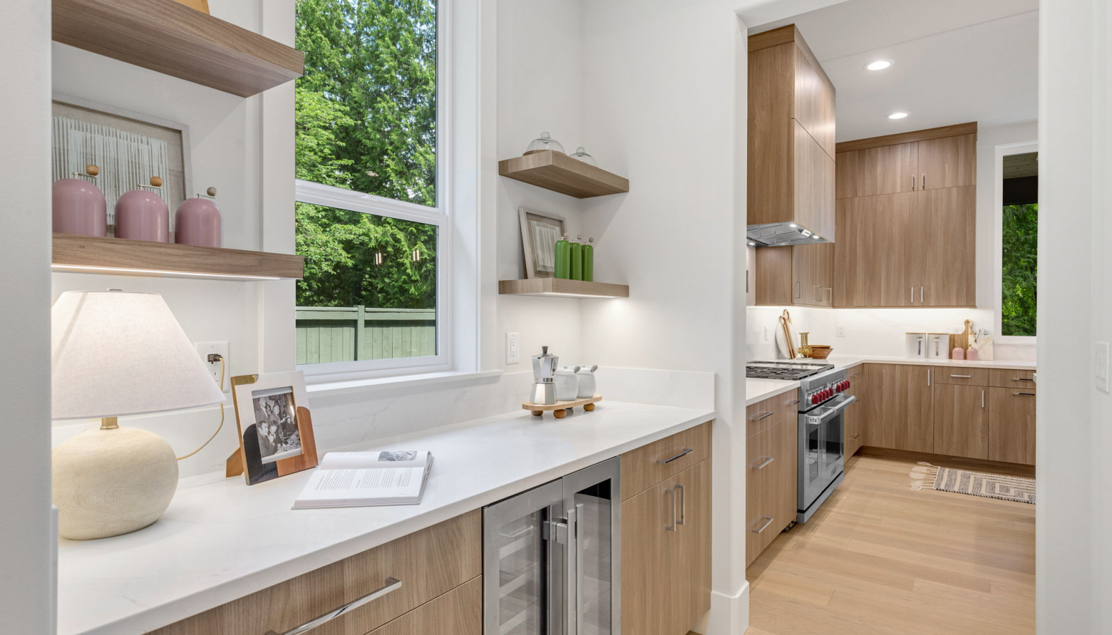 Butler’s pantry with built-in shelves, pull-out cabinets, and soft-close mechanisms. Includes an Avallon undercounter wine and beverage refrigerator for entertaining.
