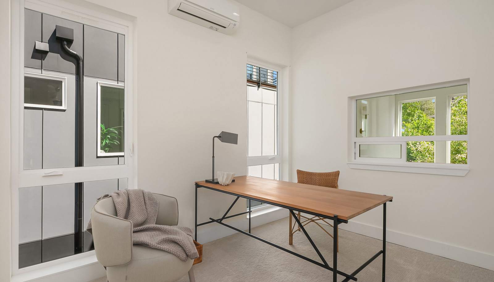 One of three additional bedrooms, currently staged as an office