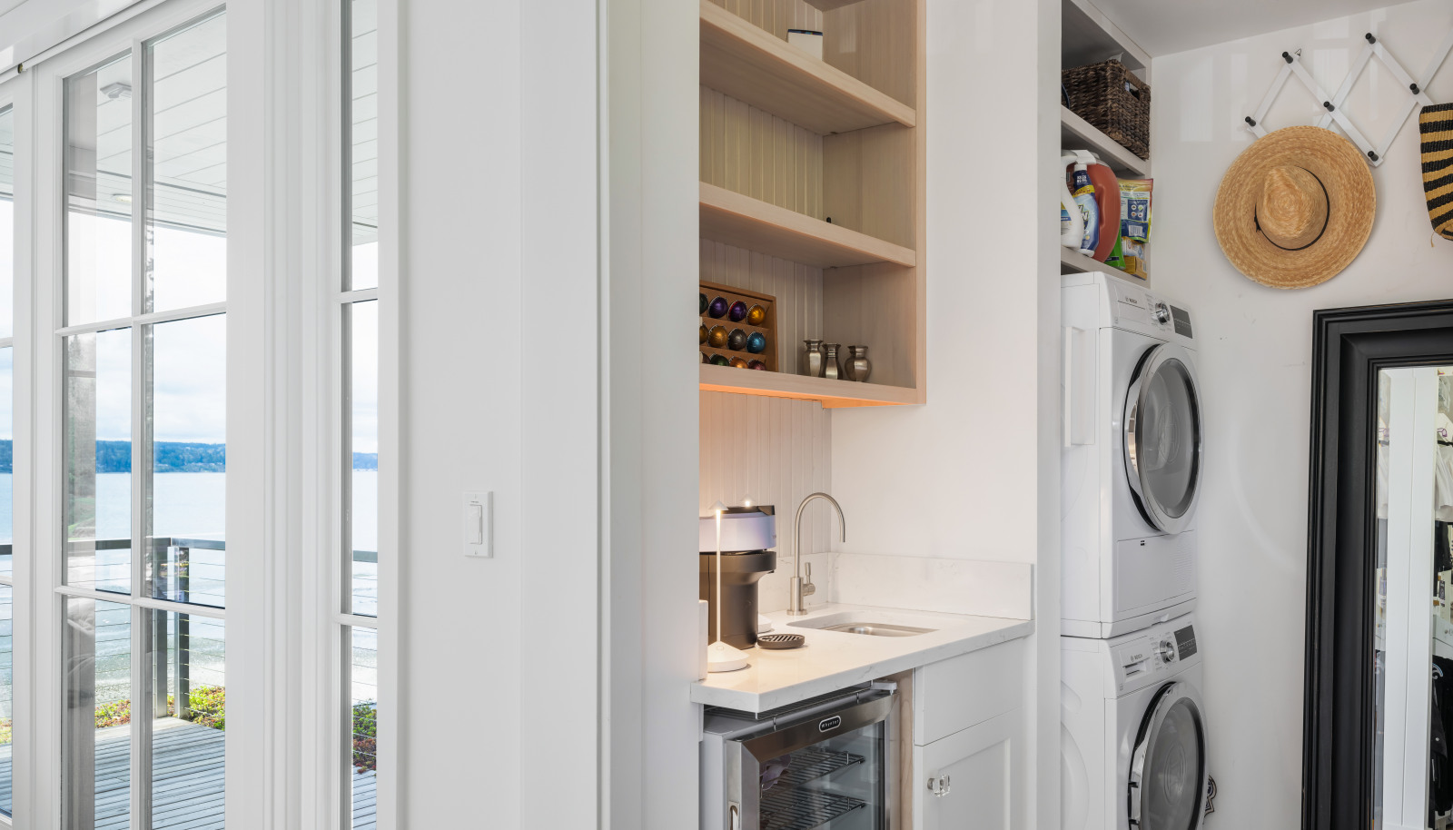 The walk-in closet is an organizer’s dream with its own washer and dryer—plus a coffee bar with a filtered water dispenser and a drink fridge